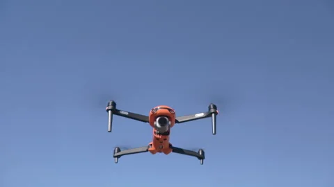 Drone flies upward against clear blue sky, showcasing aerial capabilities Vídeos de archivo 344702241