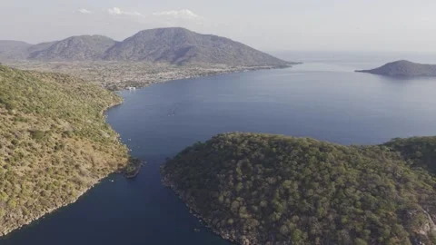 Drone flies west over gap between Domwe Island and Cape Maclear on Lake Malawi Stock Footage 339550101