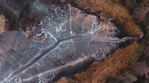 Drone flight up above abstract cracks of ice and water Stock Footage 323330849