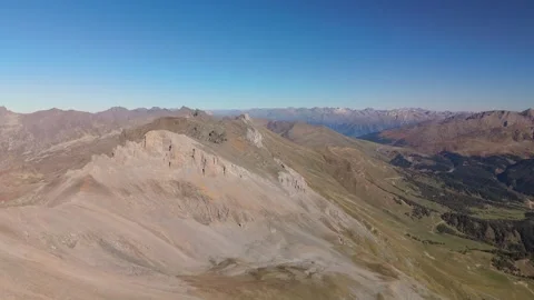 Drone flight above alpine mountain range in clear daylight Stock Footage 335764789