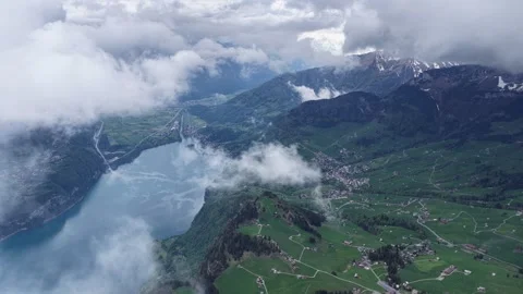 Drone flight above clouds over Walensee lake Switzerland alps Stock Footage 344848761