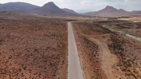 Drone flight above empty road through desert landscape in Socotra island Stock Footage 326988087
