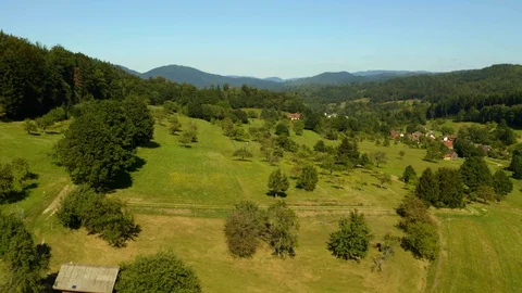 Drone Flight Above Green Field, Village on the Hills / Black Forest Stock Footage 129337381