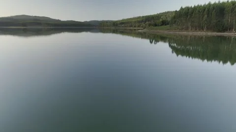 Drone flight above lagoon and trees during golden hour Stock Footage 323952247