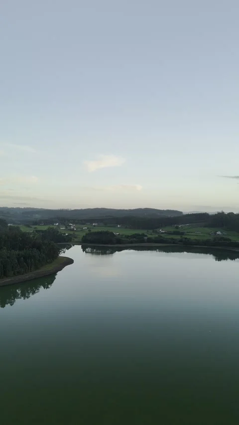Drone flight above lagoon and trees during golden hour Stock Footage 323952994