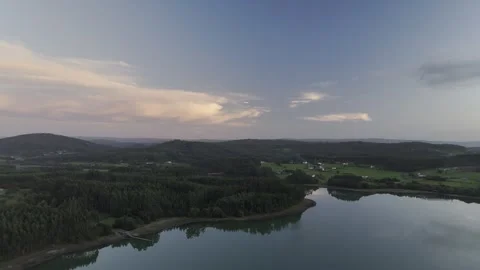 Drone flight above lagoon and trees during golden hour Stock Footage 323953545