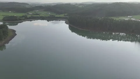 Drone flight above lagoon and trees during golden hour Stock Footage 323953743