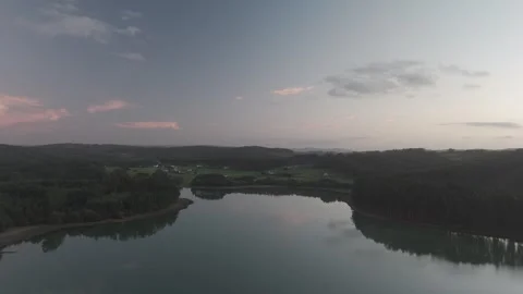 Drone flight above lagoon and trees during golden hour Stock Footage 323954352