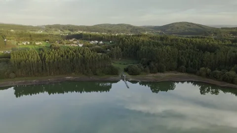 Drone flight above lagoon and trees during golden hour Stock Footage 323955435