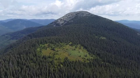 Drone flight above mountain forests and green grassland Stock Footage 338104735
