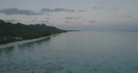 Drone flight above ocean beach line over water after sunset in Cook Islands. Stock-Footage 211710973