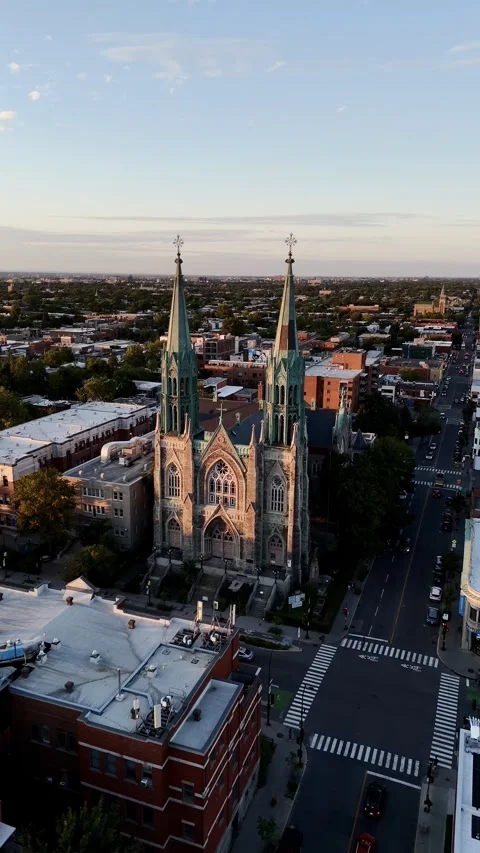 Drone flight above the Roman Catholic Saint-Edouard Church in Montreal at sunset Stock Footage 308609554