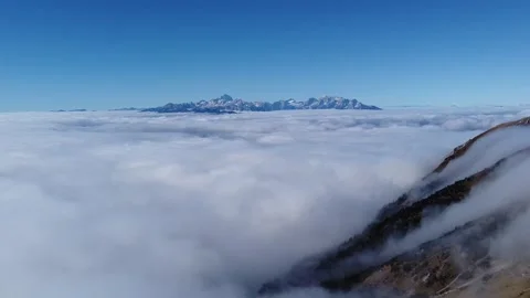 Drone flight above sea of clouds with Mount Triglav on horizon Stock Footage 328984939