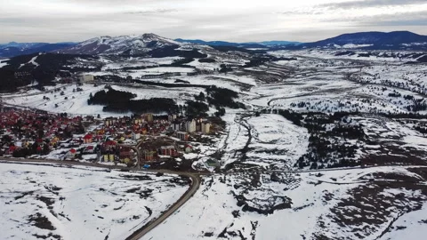 Drone flight above small town in mountain in snowy winter day Stock Footage 263242873