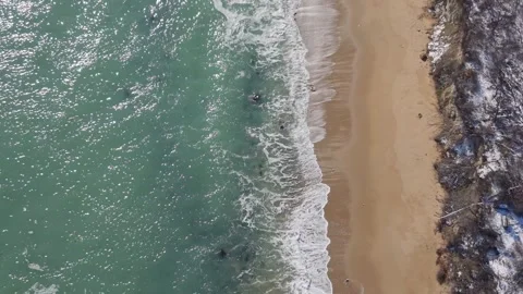 Drone flight above textured beach rocks and moving ocean waves Stock Footage 328283109