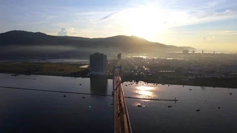 Drone flight above Thuan Phuoc Bridge toward sunrise in Da Nang, Vietnam Stock Footage 340874514