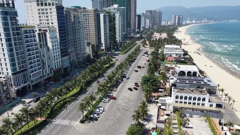 Drone Flight Above Tropical Beach Coastline and Urban Skyline Stock Footage 336382328