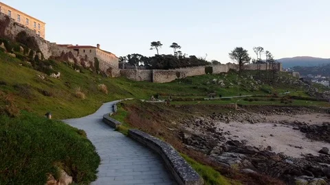 Drone flight above the walking path of the Castle in Baiona, Galicia Stock Footage 122467268