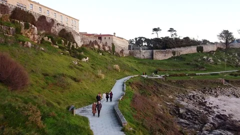Drone flight above the walking path of the Castle in Baiona, Galicia Stock Footage 122467413