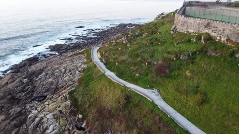 Drone flight above a walking path in Baiona, Galicia, Spain Stock Footage 122467813