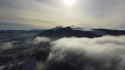 Drone Flight Above Winter Mountains with Low Clouds and Mist Stock Footage 324565662