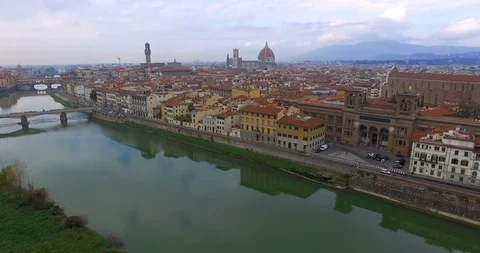 Drone flight across the Arno river and above the roofs of Italian Florence Video stock 121791982
