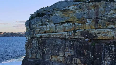 Drone flight across North Head cliffs revealing Sydney skyline Stock Footage