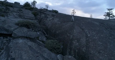 Drone flight after running to peak man on rock cliff at Yosemite National Park 스톡 동영상 117204344