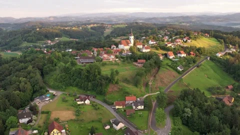 Drone flight in the afternoon over a small village on the mountain with a church 스톡 동영상 200974766