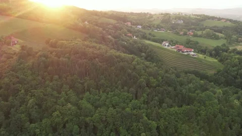 Drone flight in the afternoon over a small village on the mountain with a church Stock Footage 200974781