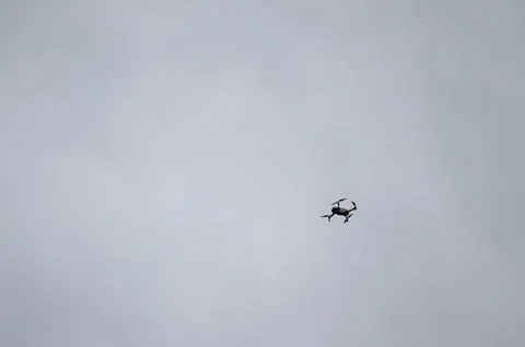 Drone in flight against a cloudy sky.  A small, unmanned aerial vehicle soa.. Fotos de archivo