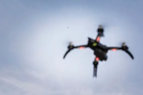 Drone in flight with airplane in the background Stock Photos