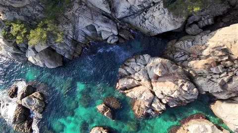 Drone Flight Along Backlit Rocky Coast at Sunrise or Sunset Stock Footage 306015158
