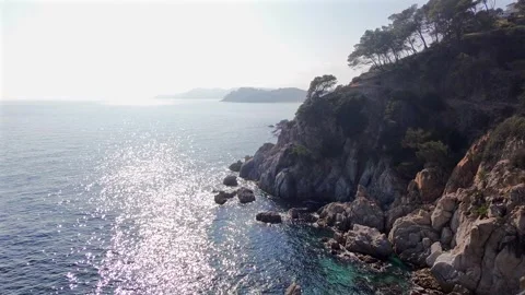 Drone Flight Along Backlit Rocky Coast, Sunrise or Sunset, Costa brava, Spain Stock Footage 306016557