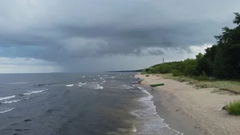 Drone flight along the beach and sea with rain clouds. Stock Footage 160340302
