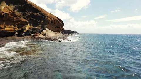 Drone flight along Costa del Silencio cliffs at Montaña Amarilla, Tenerife Vídeo Stock 330272241