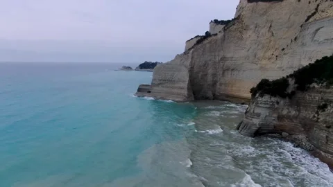 Drone flight along the dramatic white cliffs and sea stacks of Peroulades, Corfu Stock Footage 319442701