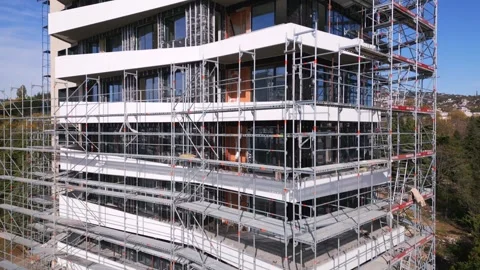 Drone flight along the facade of a modern apartment building under construction Stock Footage 255877836