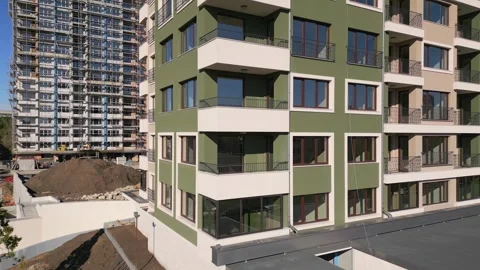 Drone flight along the facade of a modern apartment building under construction Stock Footage 256073572