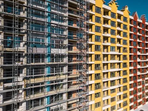 Drone flight along the facade of a modern apartment building under construction Fotos de archivo