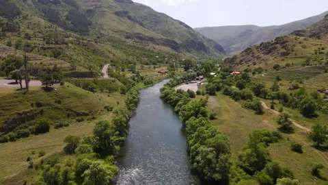 Drone flight along a narrow mountain river in Georgia Stock Footage 168678260
