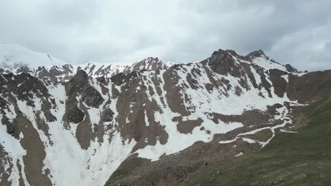 Drone flight along rugged snowy mountain ridge in Kazakhstan Stock Footage 340448904