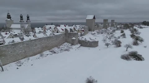 Drone Flight Along Snow Covered Visby City Wall in Östergravar Stock Footage 330034639