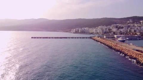 Drone flight along the stone breakwater to the pier Stock Footage 143379534