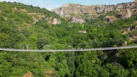 Drone Flight Along Suspension Bridge with People Over Canyon in Armenia Stock Footage 344470402