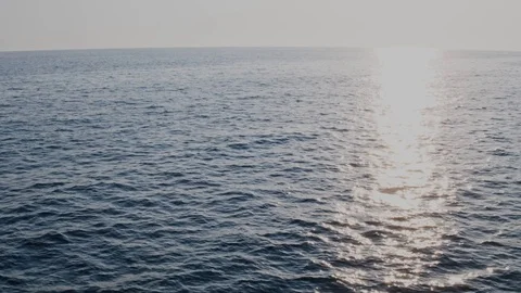 Drone flight along the waves over the sea, to meet the sun 4K Stock Footage 125832742