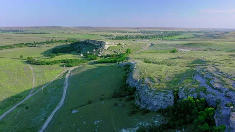 Drone flight along the white cliff at dawn at the foot of a country road and Stock Footage 152374963