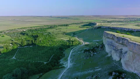 Drone flight along the white cliff at dawn at the foot of a country road and Stock Footage 152375176