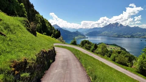 Drone Flight Along Winding Mountain Road Near Lake Lucerne Stock Footage 336833766