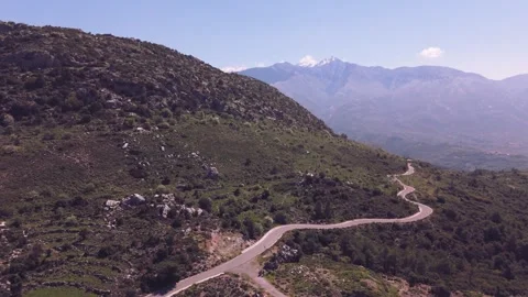 Drone Flight Along Winding Mountain Road With Snowy Peaks in Greece Stock Footage 337864857